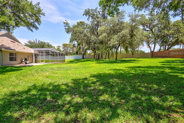 805 Woodcarver Ln, Brandon, FL 33510 - view of yard featuring a patio area and glass enclosure