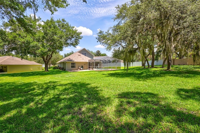 805 Woodcarver Ln, Brandon, FL 33510 - view of grassy yard with glass enclosure, a pool, and a patio area
