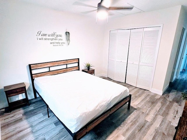 bedroom with ceiling fan, a closet, and wood-type flooring