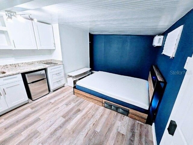 interior space featuring lofted ceiling and light wood-type flooring