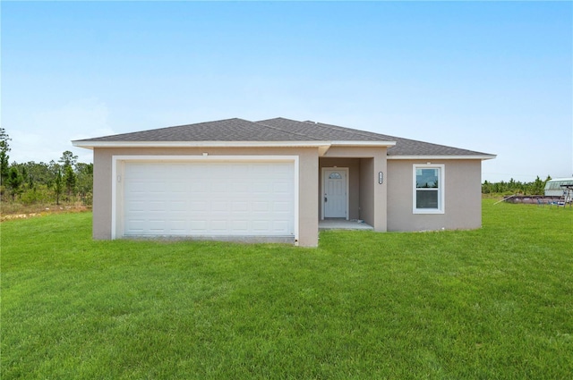 view of front of property with a garage and a front lawn