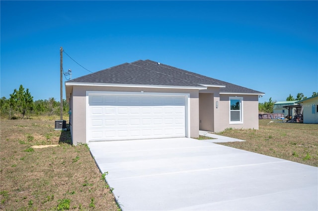 single story home with a shingled roof, driveway, a garage, and stucco siding