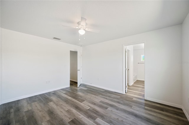 unfurnished room with a ceiling fan, baseboards, visible vents, and wood finished floors