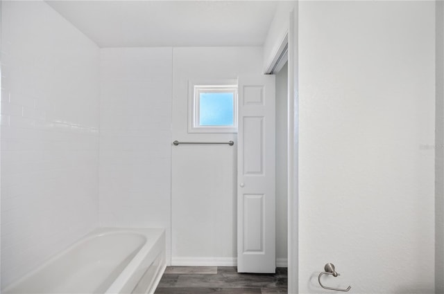 bathroom featuring shower / bath combination and wood finished floors