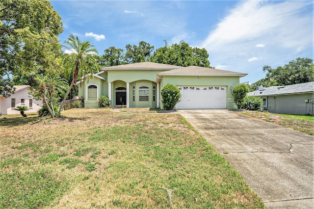 view of front of property featuring a garage and a front yard