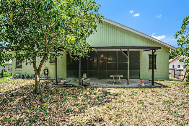 back of property featuring a patio and a sunroom