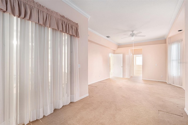 carpeted spare room featuring ceiling fan and ornamental molding