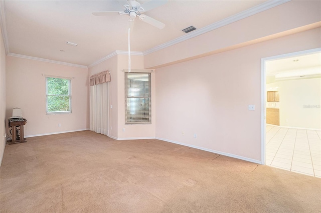 unfurnished room with ceiling fan, ornamental molding, and light carpet