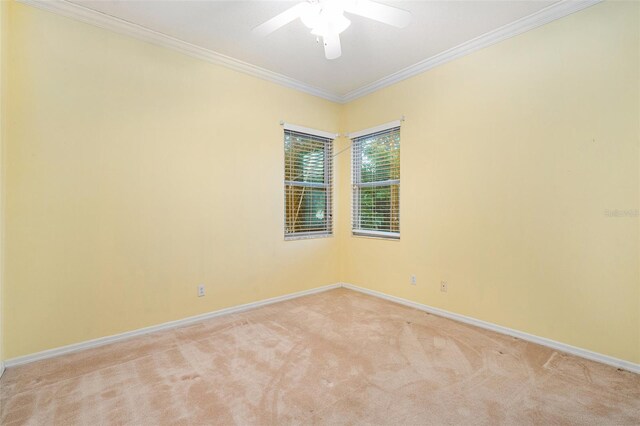 unfurnished room with light carpet, ceiling fan, and crown molding