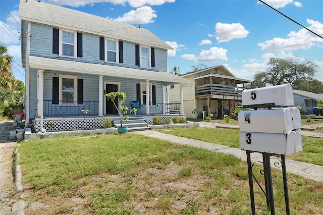 view of front of property featuring a porch and a front yard