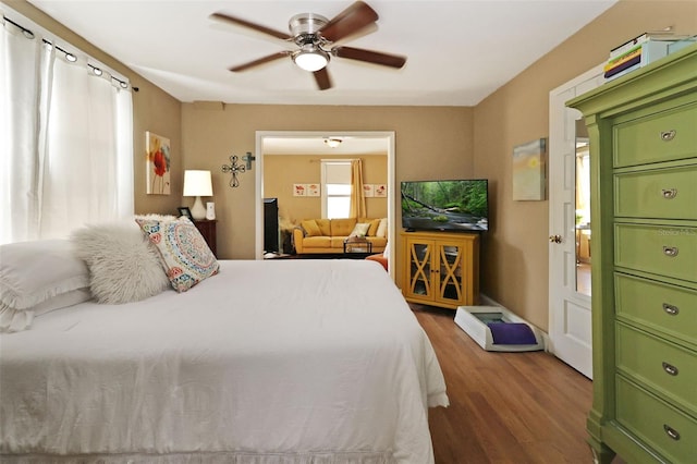 bedroom with ceiling fan and dark wood-type flooring