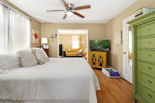 bedroom with ceiling fan and light hardwood / wood-style flooring