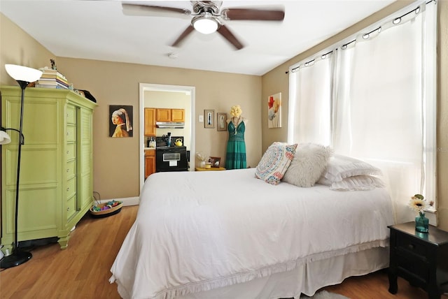 bedroom with ceiling fan and dark wood-type flooring