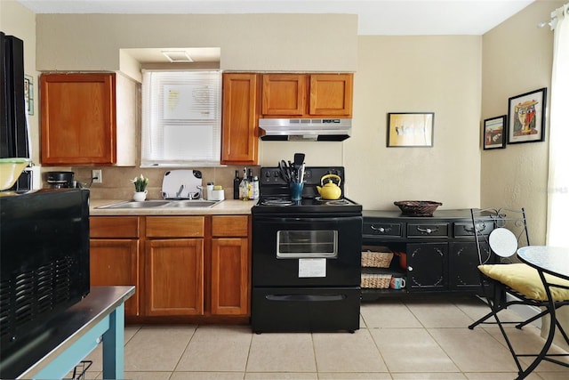 kitchen featuring light tile patterned floors, tasteful backsplash, black / electric stove, and sink