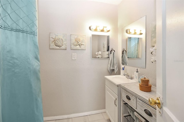 bathroom featuring tile patterned flooring, vanity, and walk in shower