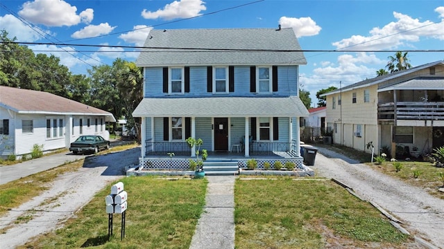 view of front of house featuring a front yard and a porch