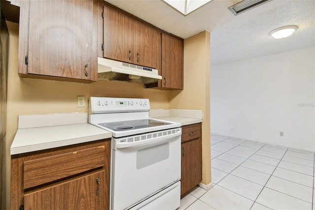 kitchen with light tile patterned floors, a textured ceiling, and white electric stove