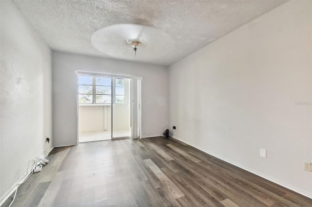 spare room with hardwood / wood-style flooring and a textured ceiling