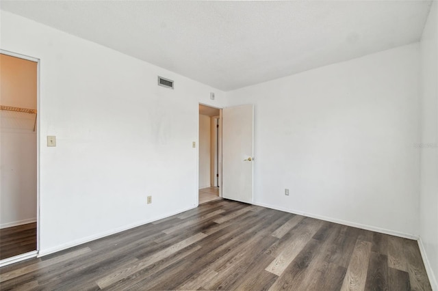 empty room featuring dark hardwood / wood-style floors