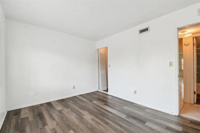 unfurnished room featuring dark hardwood / wood-style flooring