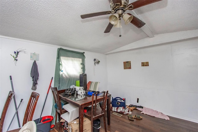 dining space featuring hardwood / wood-style floors, lofted ceiling with beams, a textured ceiling, and ceiling fan