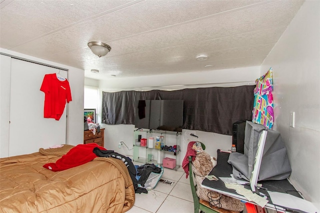 tiled bedroom featuring a closet