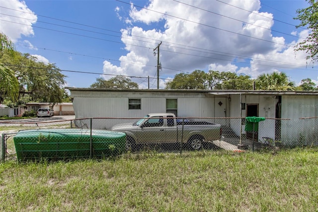 rear view of house with a yard