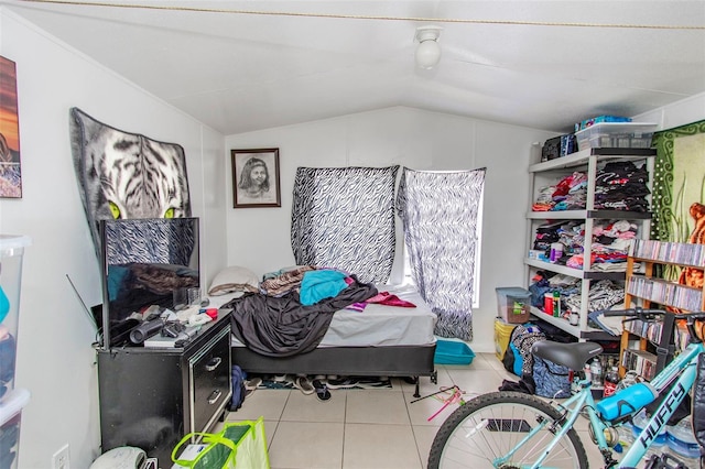 bedroom featuring lofted ceiling and light tile patterned floors