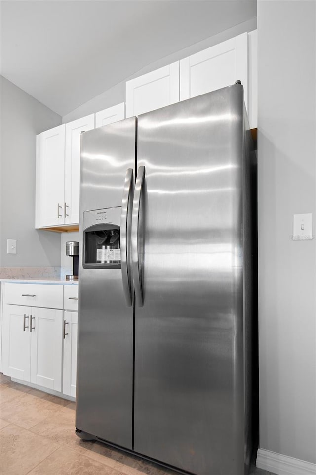 kitchen with white cabinets and stainless steel fridge