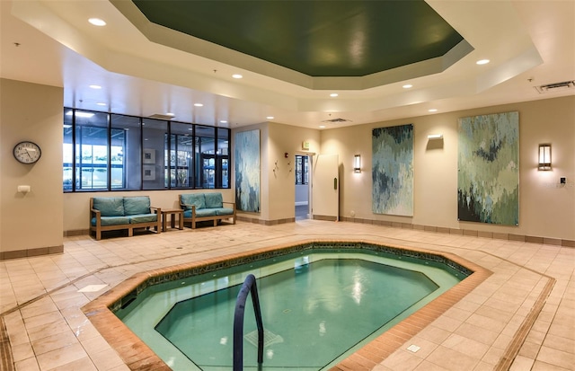 view of swimming pool featuring an indoor hot tub