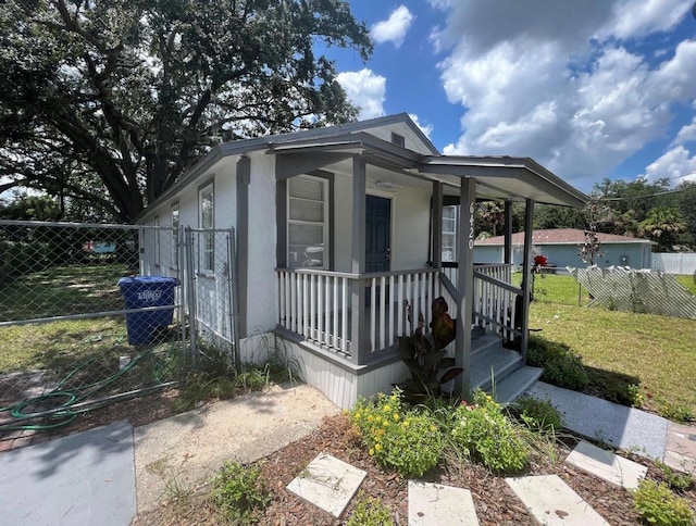 view of front of property with covered porch and a front lawn