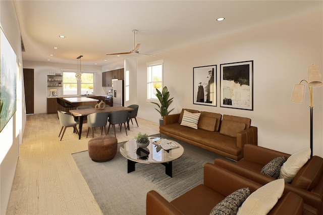 living room featuring ceiling fan and light hardwood / wood-style flooring