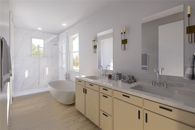 bathroom with shower with separate bathtub, hardwood / wood-style flooring, and vanity