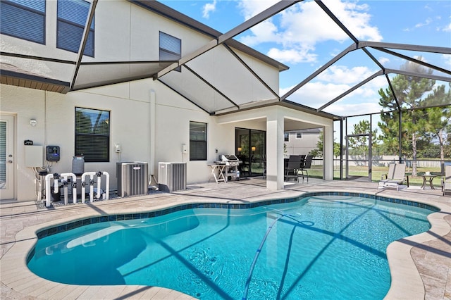 view of pool featuring glass enclosure and a patio area