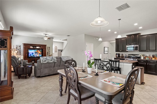 tiled dining area featuring ceiling fan