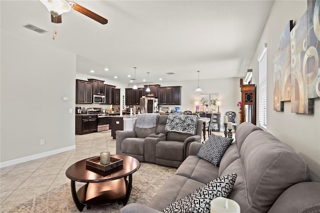 living room with ceiling fan and light tile patterned floors