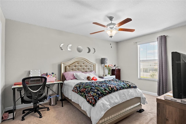 carpeted bedroom featuring ceiling fan and a textured ceiling