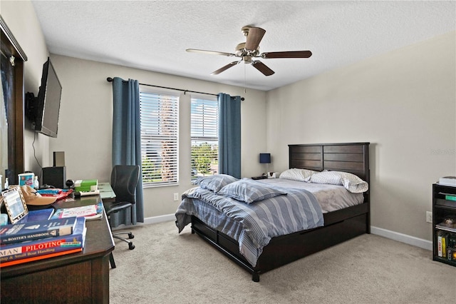 carpeted bedroom with a textured ceiling and ceiling fan