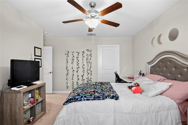 bedroom featuring light carpet and ceiling fan