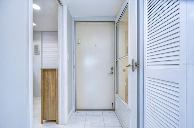 hall featuring light tile patterned flooring