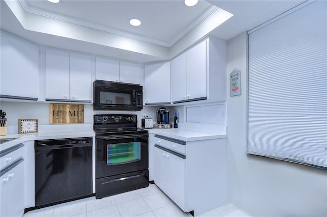 kitchen featuring white cabinetry, light tile patterned floors, black appliances, and ornamental molding