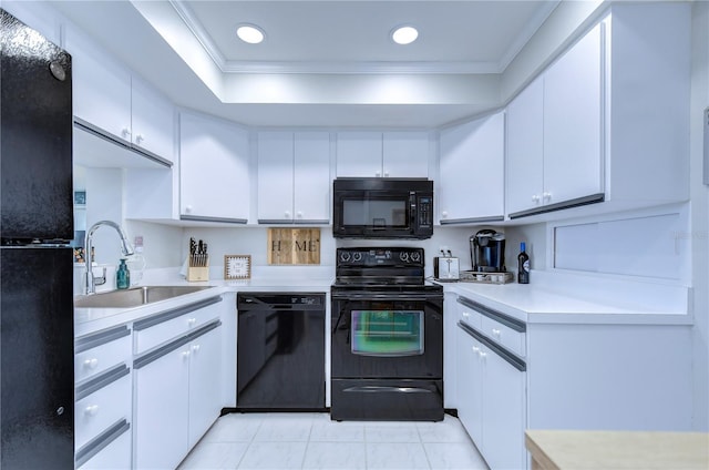 kitchen featuring sink, white cabinetry, and black appliances