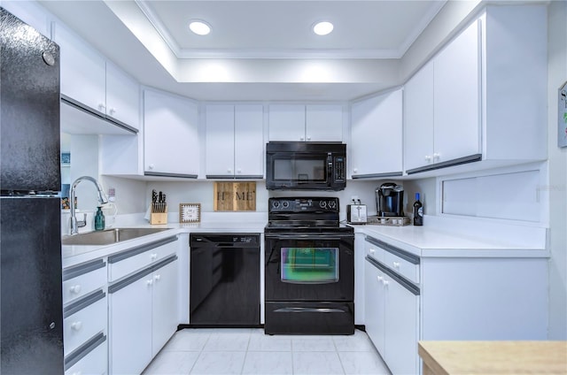 kitchen with white cabinets, sink, crown molding, and black appliances