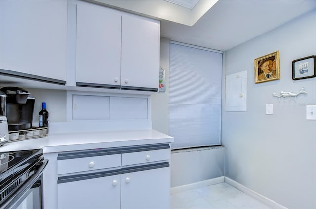 kitchen with electric panel and white cabinetry