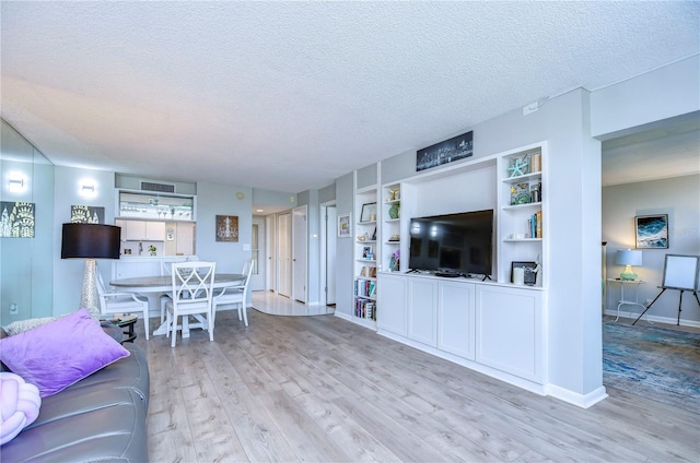 living room featuring light hardwood / wood-style floors and a textured ceiling