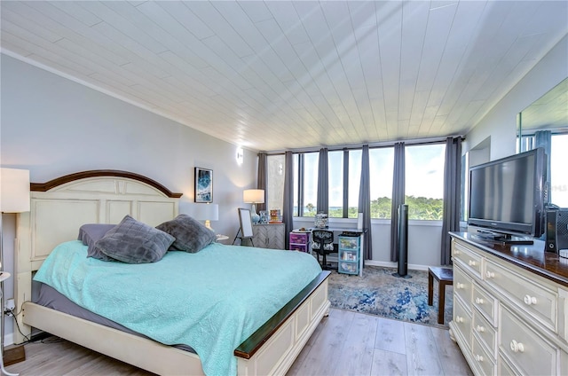 bedroom featuring light hardwood / wood-style floors, crown molding, and wood ceiling