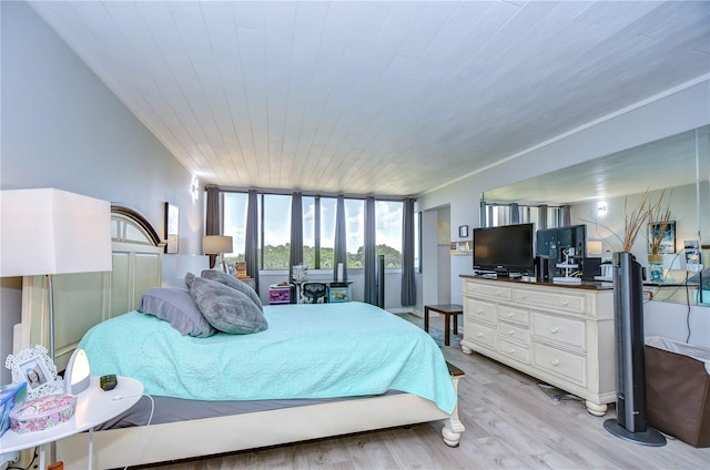 bedroom with wood ceiling and light wood-type flooring