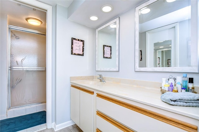 bathroom with a shower with door and vanity