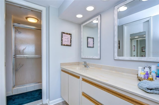 bathroom featuring vanity and a shower with door