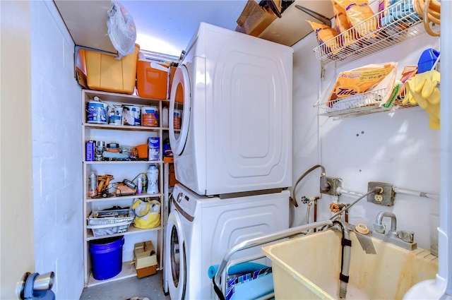 laundry room featuring sink and stacked washer and clothes dryer